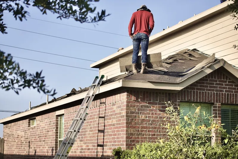 Professional roofer working on a residential roof in River Ridge Estates